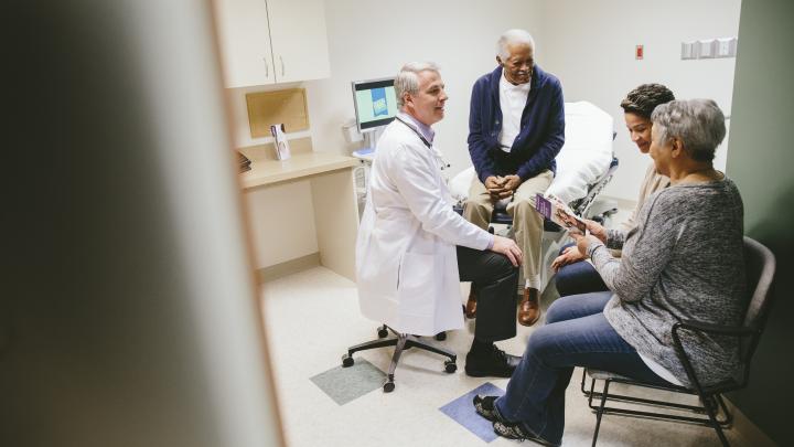 Doctor with patient and family