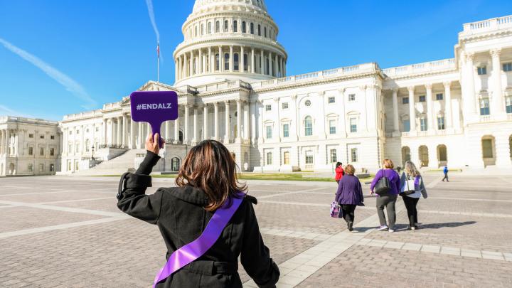 Woman's Back to Capitol with #ENDALZ Sign