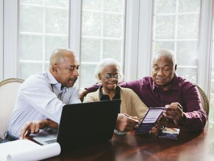 An image of a Family Inside Looking at Pamphlet.