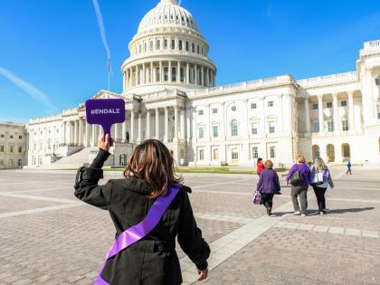 Woman's Back to Capitol with #ENDALZ Sign