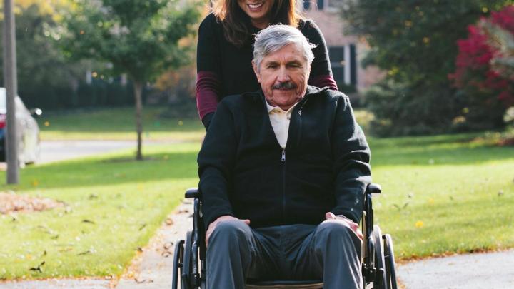 An image of a Family Caregiver with Patient in Wheelchair
