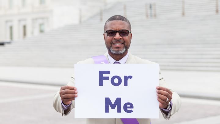 Man with For Me sign