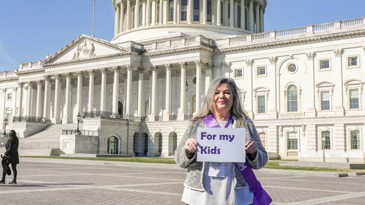 woman with for my kids sign