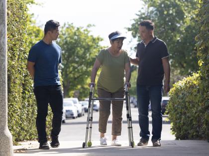 An image of Asian Sons Outside with Mother and Walker