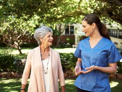 Home Health Aid and Patient Walking Outside
